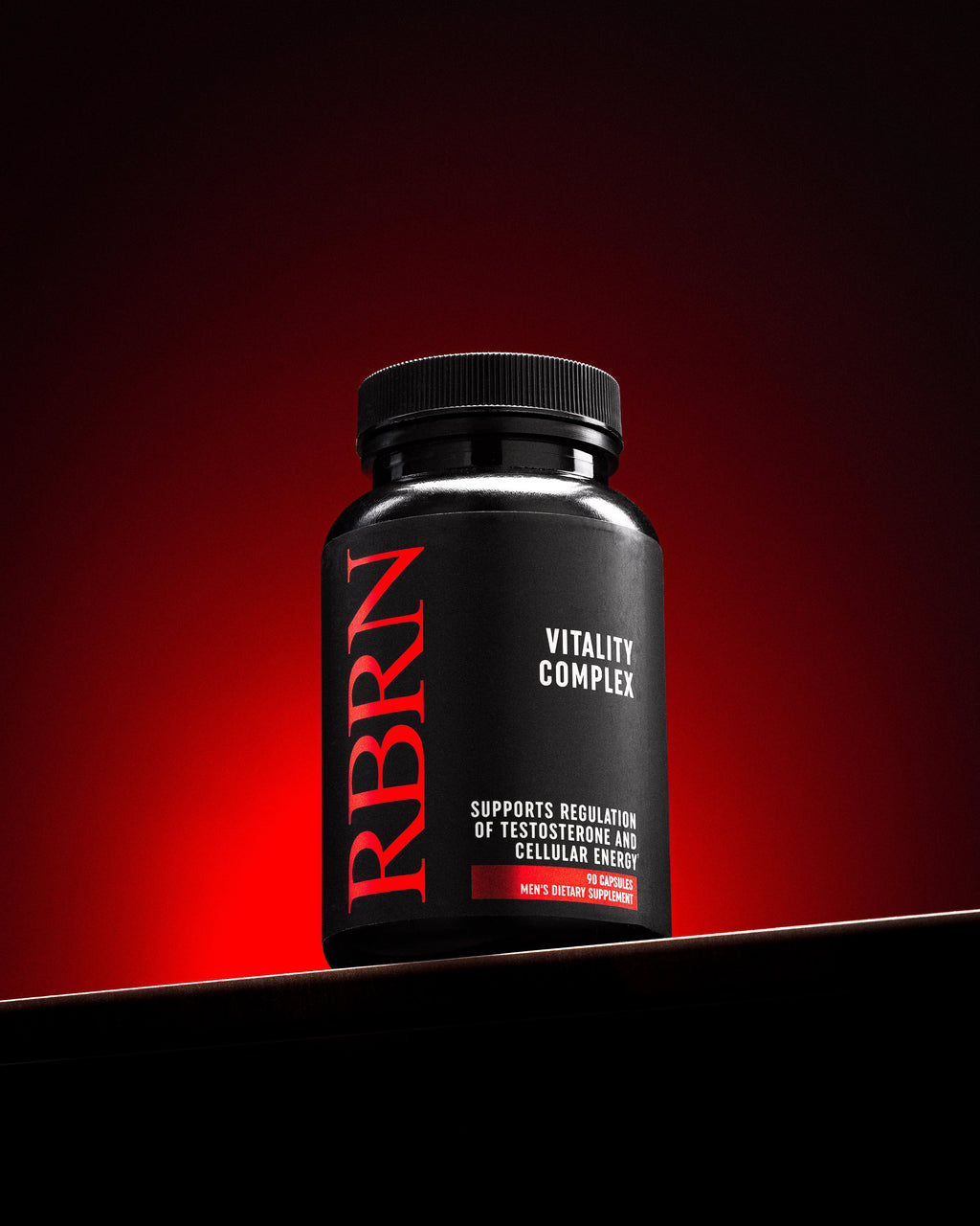 RBRN Vitality Complex men's testosterone support and cellular energy supplement bottle against a red-lit background